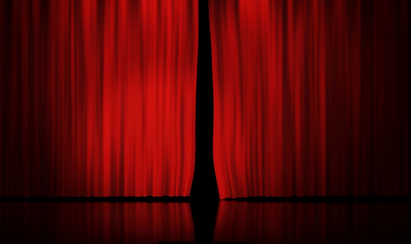 Imagem ilustra a oficina de teatro com a uma cortina vermelha sobre um palco de teatro