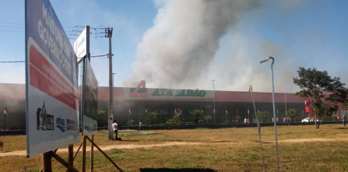 Foto mostra coluna de fumaça saindo do estabelecimento em chamas